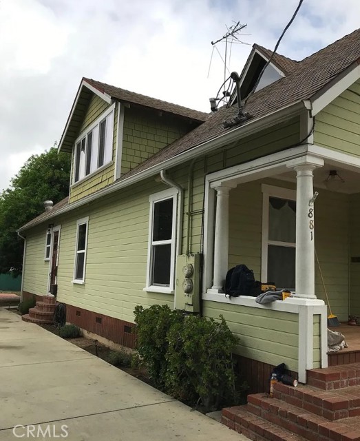 Side view of house and entry to attic unit.