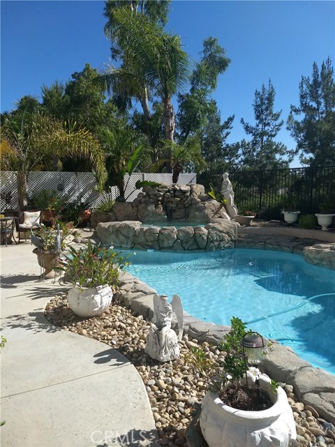 43132 Pudding Court Temecula, California Enjoy the amazing solar heated pool with waterfall and spa, view and quiet private backyard of this highly upgraded home located on a premium cul de sac lot in CROWNE HILL. Kitchen has been upgraded with quartz counter tops and new appliances in 2019. High quality wood laminate flooring throughout. Vaulted ceilings in living and dining rooms add to the spacious feel, and kitchen is light and bright with built-in desk and convenient island. HUGE family room will accommodate the largest family and layout is perfect for summer entertaining, with slider leading to a shady covered patio and gorgeous backyard/pool area. Extra large laundry room and half bath on 1st floor, with 4 good sized bedrooms upstairs. Master en-suite is especially spacious, with retreat opening to a tempered glass balcony overlooking the backyard and forever views. Master bath has dual sinks, separate shower, tub,and spacious walk-in closet with built-ins.