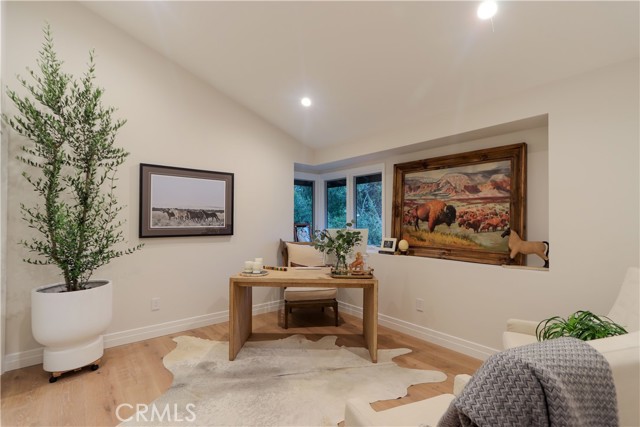 One of two entry-level bedrooms. This one is staged as an office near the front door and guest bathroom should clients visit.