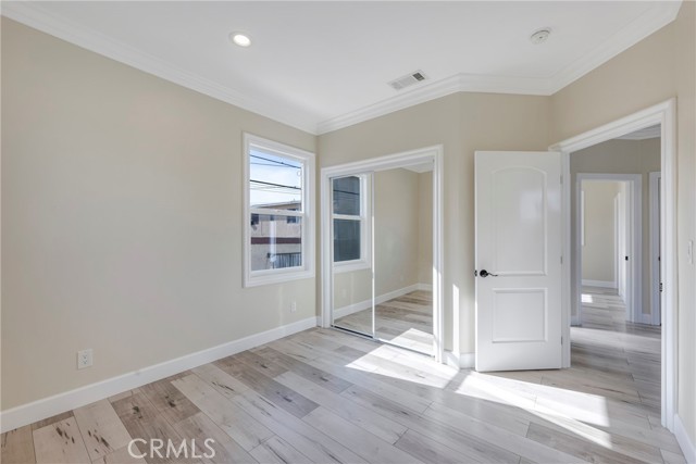 First secondary bedroom has mirrored closet doors.