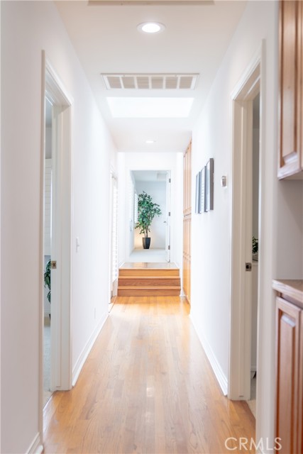 Skylights & French doors to backyard in the hallway