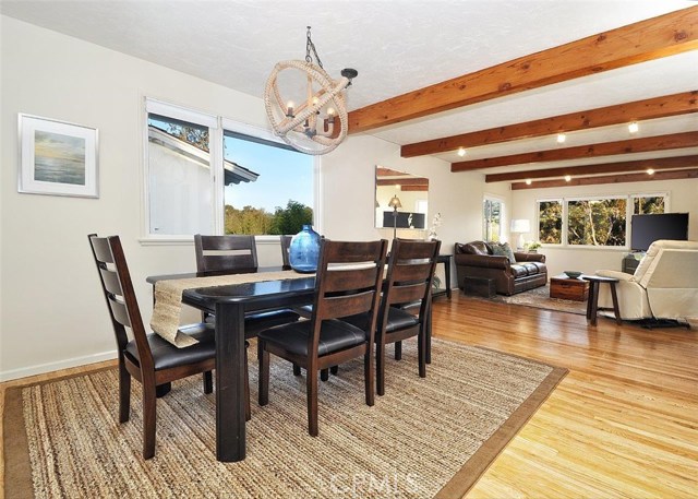 The dining room opens to the living room and overlooks a view of the rolling hills.