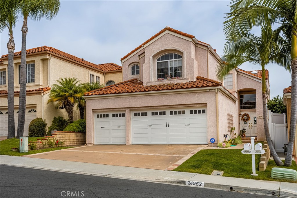 Welcome to coastal living at its finest in Niguel Ranch one of Laguna Niguel's most sought after communities. This home's prime location is an easy drive to some of Southern California's most beautiful beaches and prestigious resorts like Waldorf-Astoria, Ritz Carlton, and Montage. Located on a peaceful cul-de-sac street, this upgraded residence offers 2371 sq ft of living space (est), 4 bedrooms and 3 full bathrooms including a downstairs bedroom and full bath.  This home boasts upgrades and unique features throughout. Step through the elegant cut-glass double front doors into an entryway leading to the living room graced with cathedral ceilings and a custom fireplace providing a place of warmth and comfort. The magnificent vaulted ceilings and recessed lighting along with abundant natural light create a truly inviting ambiance. The remodeled kitchen features granite countertops, stainless steel appliances, and a chef's island. An open floor plan seamlessly flows from kitchen to both the dining room and family room which offers a charming fireplace with a custom designed wooden mantlepiece. Adjacent to the family room are sliding doors leading to a beautifully maintained backyard with an elevated view toward the coast, a perfect space for relaxation and entertainment. Upstairs features 3 bedrooms, including the primary with two walk-in closets, a stunning arch window looking out over a picturesque view of the Valley below. Additional highlights include new engineered wood flooring downstairs, new interior paint, solar panels, inside laundry room, and an oversized 3-car garage.  Enjoy the convenience of living in the Niguel Ranch Community, with close access to beaches, parks, trails, tennis and sports courts, playgrounds, and top-rated schools. With its prime location, modest HOA dues, low 1.01% tax rate, no Mello-Roos, this property welcomes you to the best of Southern California living. Schedule a private viewing today or come to this Saturday's open house and WELCOME YOURSELF HOME to 24952 Eaton Ln Laguna Nigel!