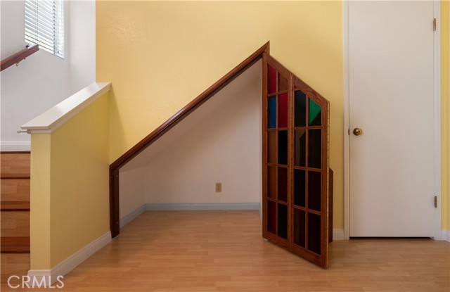 Custom built storage space underneath staircase.