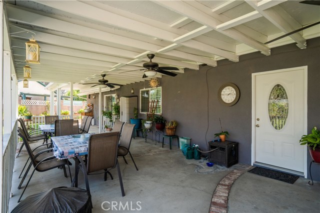 COVERED PATIO WITH SINGLE DOOR AND DOUBLE GLASS SLIDING DOORS LEADING TO 1ST MASTER SUITE