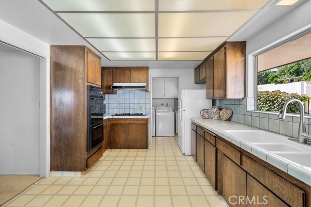 Kitchen with attached laundry and pantry.