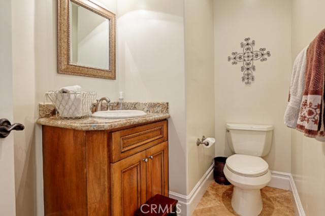 Powder room - note the granite countertops and travertine flooring. Powder room - note the granite countertops and travertine flooring.