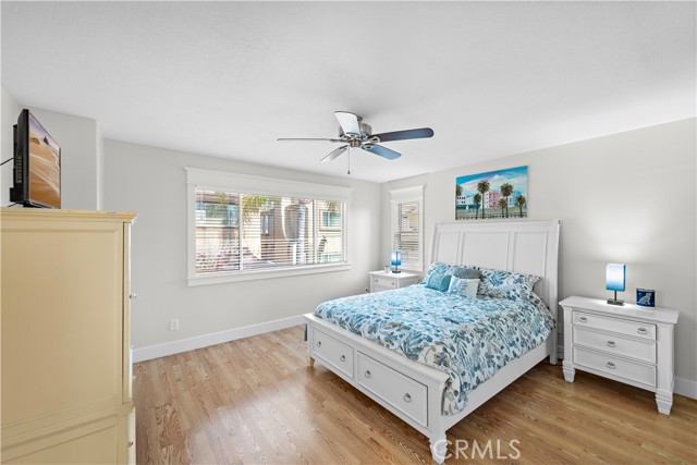 The ample primary bedroom has lots of natural light and a ceiling fan. Notice the upgraded baseboards (throughout the home) and the craftsman-like encased windows (again, throughout the home).