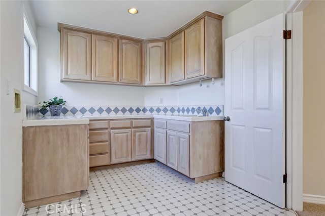 Laundry room with loads of storage and sink