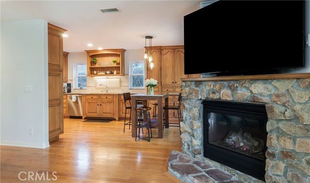 Family room with fireplace flows off the kitchen