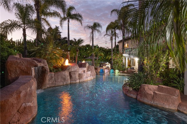 Experience the winding saltwater pool and spa with its upgraded grotto, Baja deck, and mosaic tile, all solar-heated.