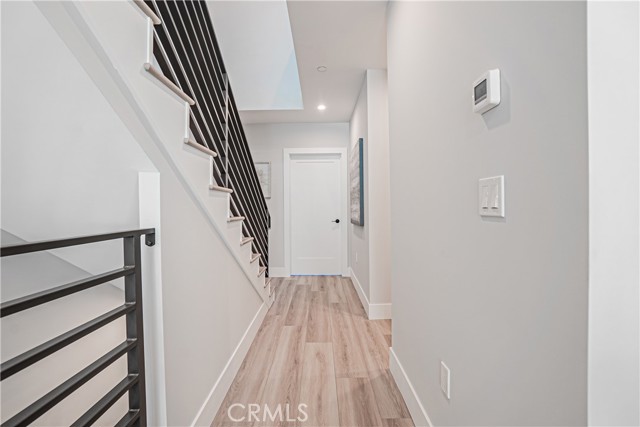 Main level hallway with access to third level bedrooms and laundry rooms.
