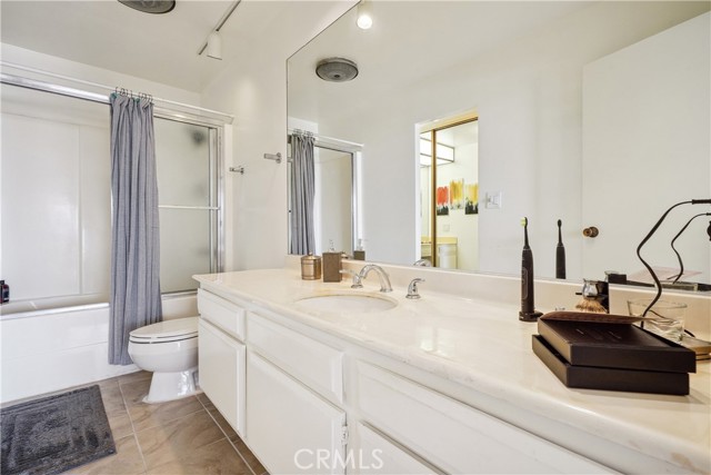 The Larger Master Bathroom Has a Large Vanity with Abundant Storage and a Shower Tub