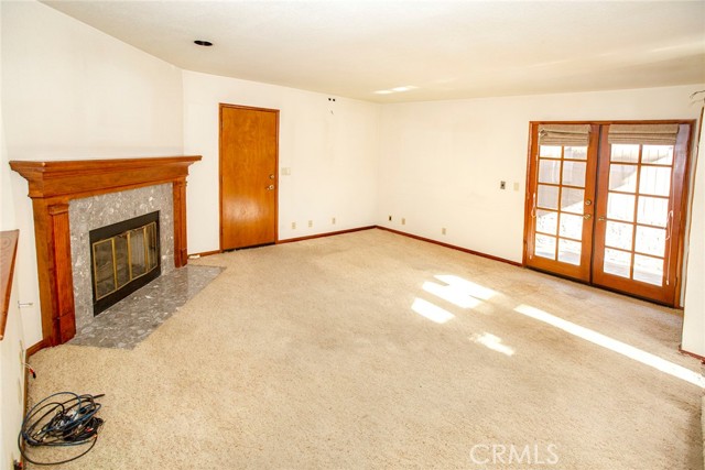 Family Room: Fireplace, direct access garage door and French Doors to side patio