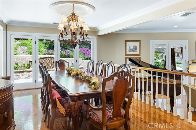 Formal dining room overlooks the living room and offers French doors that overlook and lead to the backyard.
