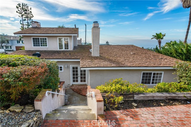 Steps from the house to the flat brick patio.