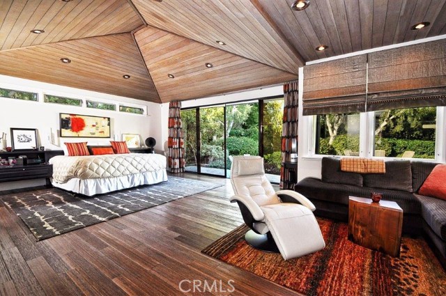 Stunning and spacious master bedroom with large sliding glass doors that open to the outdoor living area