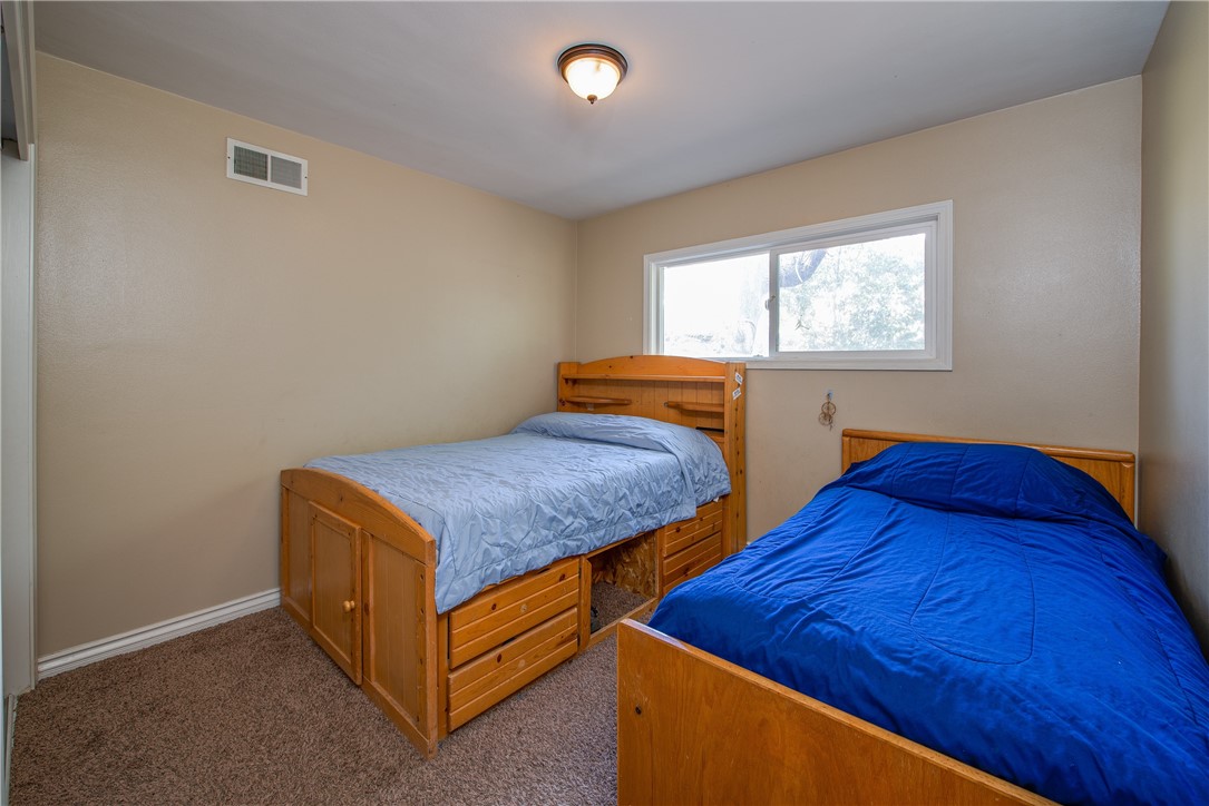 Bedroom 2 is roomy and on the side of the home with a framed dual paned window and large closet.