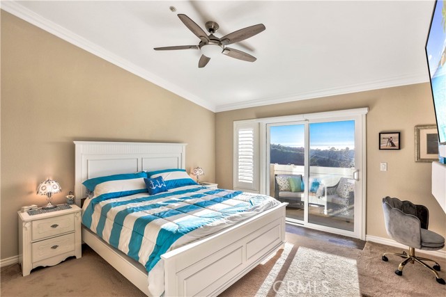 Another view of the upstairs master bedroom. The private balcony is the perfect spot to soak in the ocean views all year long.