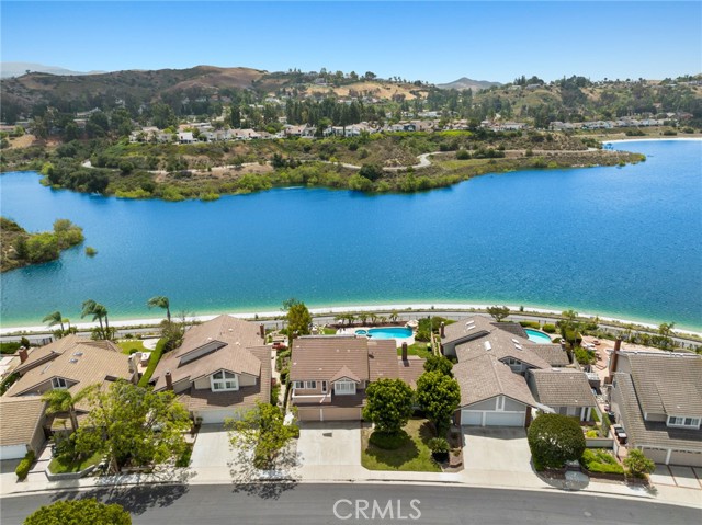 Amazing opportunity to own waterfront property in Anaheim Hills.  This beautiful 4 bedroom, 2.5 bath home sits atop the gorgeous blue waters of the reservoir and features an oversized backyard with pool, waterfall and spa.  It has all the feels of being at the beach without the messy sand and sharp edged shells in your feet. Enter the home to an enormous living room with vaulted ceilings and raised travertine fireplace that leads perfectly to an elevated half loft space perfect for an office, play room or sitting area.  The large dining room is perfectly situated next to the kitchen but perhaps more importantly features French doors leading to the gorgeous backyard.  The kitchen itself hosts stainless steel appliances, granite counter tops, an island, custom tile backsplash and amazing views.  The family room is the perfect place to hang out, watch some tv and enjoy the homes second fireplace with designer custom finishes.  Upstairs features three secondary bedrooms and a hall bath as well as a massive primary bedroom with vaulted ceilings, an attached master bath with walk in closet and your very own balcony.  This home is located near all of the amazing stores and restaurants that Anaheim Hills has to offer and highly rated schools.  You really won't find a better opportunity in today's market and will feel proud to call this house your home.