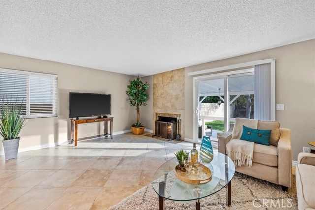 Travertine-tiled fireplace and slider to backyard on living rooms' south wall.