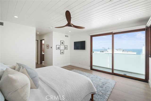 Primary bedroom looking at ocean and primary bath