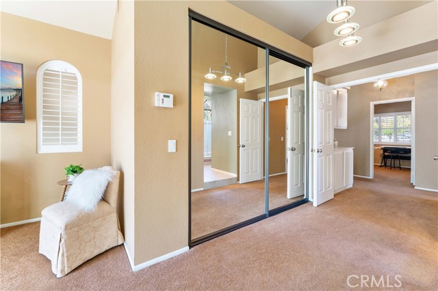 Double door entry to primary suite with mirrored doors to walk in closet.