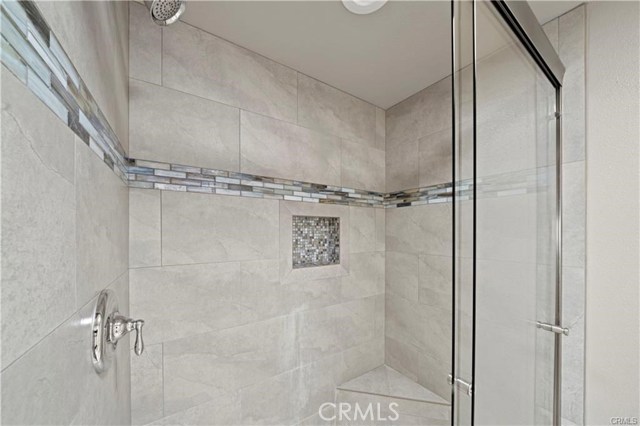 The resort-inspired step-in shower with beautifully inlaid tile design and upgraded fixtures.
