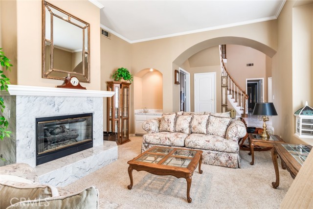 Sunken Living Room with Raised Hearth Fireplace and a Wet Bar