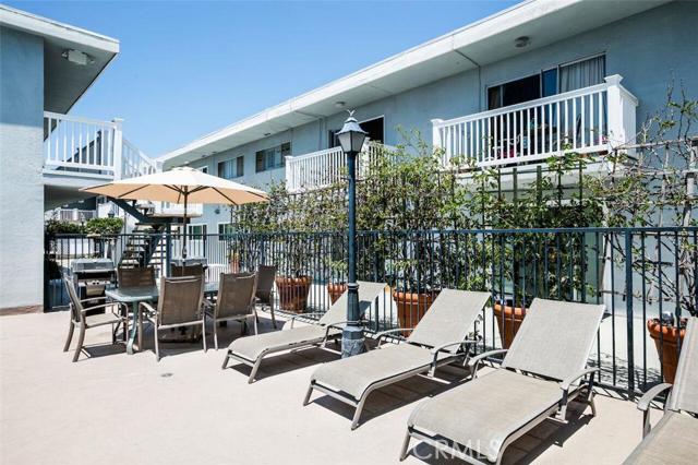 a  close up of pool side with lounge chairs for relaxing and a table for eating.