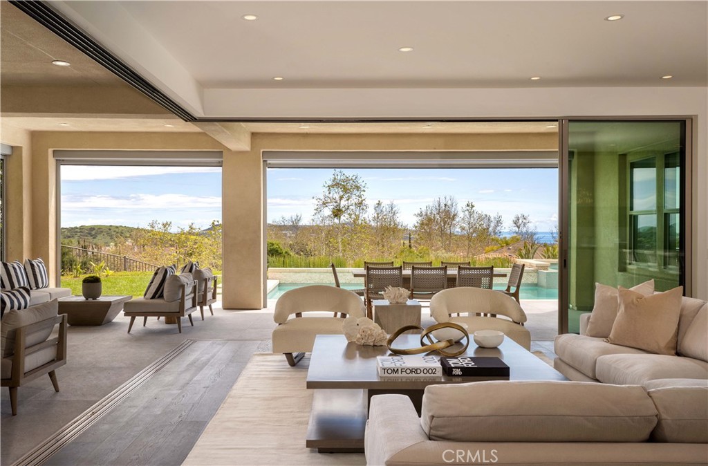 One of the finest ocean view homes ever offered in San Clemente, this spectacular semi-custom home just underwent a multi-year reconstruction making it into the epitome of coastal luxury living. Sited within the coveted Alta area of Talega, this premier elevated corner location is exceptionally private, yet open, light and features horizon views of the Pacific and sunsets. One of only seven homes on this serene cul-de-sac, the house has been transformed with all the design elements and appointments to rival that of a new custom residence at twice this price. Walls were removed to expand the views and sightlines, lending to the atmosphere of this idyllic indoor/outdoor plan. A veritable paradise, a generous covered loggia (warmed by a fireplace) and mature gardens surround the private areas of the house and open to  more terraces and an ocean view pool. Substantial and one-of-kind additions and improvements include: a private spa/gym/wellness retreat was created with an accompanying spa bath with steam shower; an expanded master suite with a sumptuous and elegant bath, dressing, and view terrace; a completely reconfigured and rebuilt kitchen with adjacent serving bar and a secondary preparatory kitchen fitted with an island as well as a custom designed and refrigerated produce and wine room; a meditation room insulated for silence (and easily converted to a golf simulator room); and a floating all-steel and stone clad staircase in the dramatic two-story entry distinguish this residence from all others. Details and appointments include new electrical and Lutron lighting systems throughout, a Generac back-up generator, custom inlaid and mosaic marble tiles, custom hand-crafted closets and built-ins throughout (including murphy beds), custom lighting+hardware+fixtures throughout, handcrafted solid hardwood floors, a Kalamazoo barbeque, and a spectacular custom metal entry door with custom designed glass insert. Truly, there are simply too many upgrades to cover in this description. Suffice to say that every inch of this home was reconsidered and redesigned to make it the ultimate contemporary version of what it could be. All of this was thoughtfully recreated in this highly desirable ocean-close location minutes from the coast’s finest amenities. For those in search of a substantial ocean view home in this award-winning community, but for whom the standard builder grade is not enough, you need look no further than here. You have found your new home.