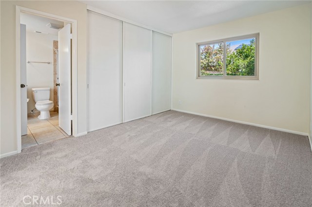 Downstairs bedroom w/ tall triple closet connects to bathroom