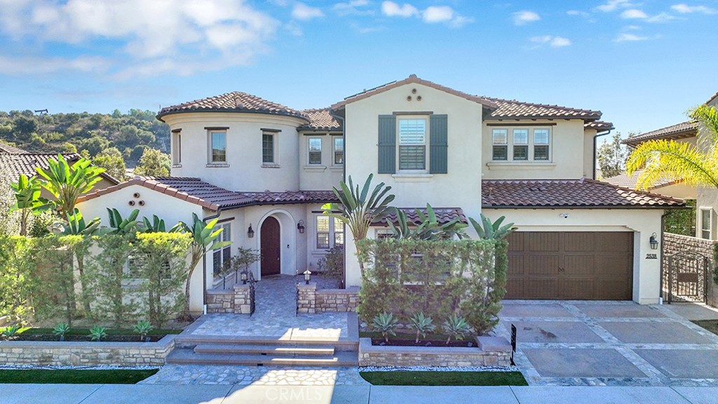 Welcome to 2538 E Santa Paula, boasting the largest floor plan at Avignon in the highly coveted Blackstone community of Brea. Built in 2014, north facing, this luxurious and elegant home, filled with amazing natural light, consists of 5 bedroom & 5.5 bathrooms, 1 large bonus room, 1 office/library, 1 study/art room, 1 butler's kitchen room, & exercise/yoga room with full walled mirror. Enter through the private gated courtyard into the grand entrance, you will instantaneously fall in love with the bright and airy open floor plan, soaring high ceiling, spiral staircase, huge kitchen island, spacious and warm layout, exquisite wood flooring, moldings, plantation shutters, recessed lighting, tons of built-ins & upgrades. Home is perfect for multi-generational living. On the main floor, you will find a mother-in-law quarters with its own kitchenette & full bath, main kitchen & prep kitchen, library/office with plenty of built-in shelves, and kid's study room/art room with built-in computer station/desks, and formal dining room that opens into great room with wall to wall slider that leads to entertainer dream backyard with custom built-in BBQ grill, fridge, fire pit for those cold / romantic nights, pavement and pavers that enlarged recreational space for basketball & other sports. On the seconnd floor, there is an enormous bonus room with a wet bar/kitchenette, which can be easily converted into the 6th bedroom or family theater. Fall in love with extravagant inviting master suite with a private bath consisting of dual separate shower & soaking tub or relax on the private master suite balcony and watch the sunrise & sunset and green mountain view. Other features include: fresh custom paint throughout, automatic full privacy awning in patio and blinds in master bedroom, added outdoor patio TV & 4 wall installed flat screen smart TVs, two solar systems & two Tesla batteries, 2 reverse osmosis in-house water filters, whole house water filtration & softener, Google nest wired security system & ring doorbell camera. The Blackstone community enhances your lifestyle with a resort-like pool, a beautifully maintained park & a security patrol for added peace of mind. Situated within the top-ranking Brea Olinda School District and 10-minute away from Troy High, Brea Mall and easy access to 57 & 91 FWY, this home offers the perfect blend of luxury, comfort and community & is surrounded by great neighbors. This beautiful home is ready for you to create lasting memories...