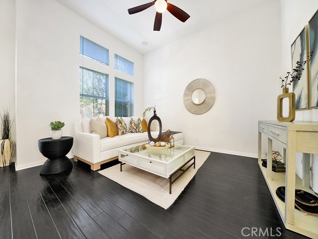 Living room with built in speakers in ceiling, engineered wood floor