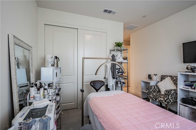 The second primary bedroom upstairs. You are greeted by the door that closes this entire space off. The bathroom is tucked away behind the closet. The en-suite bathroom has tub/shower, sink vanity, mirror with lights above and tile flooring. Bedroom has burbor carpet.