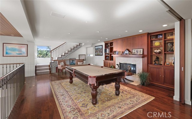 Library with fireplace and pool table