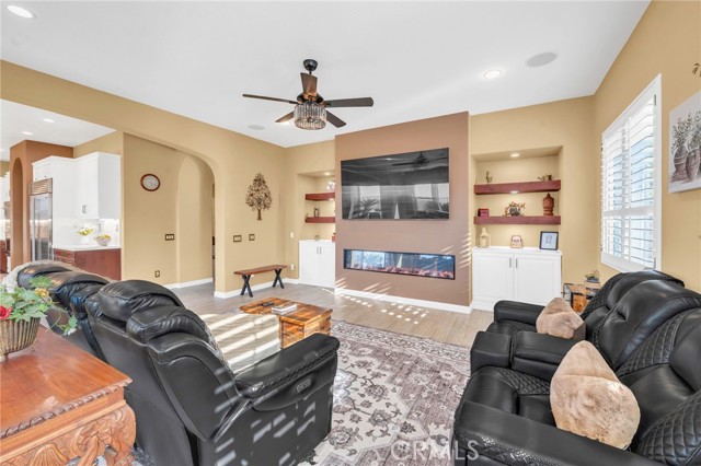 Alternate view of family room with custom fireplace and custom built shelves and cabinets