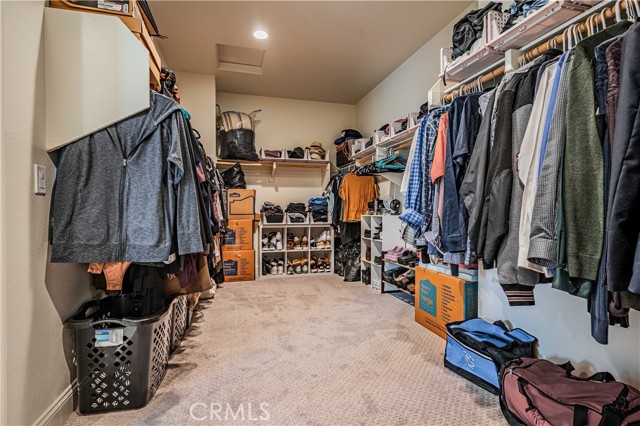 Walk-in closet in the first primary upstairs bedroom off of the en-suite bathroom.