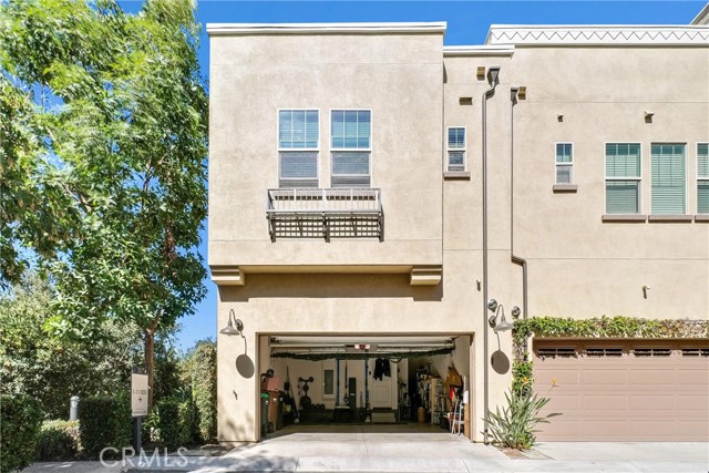 Rear view of property with full view of garage.