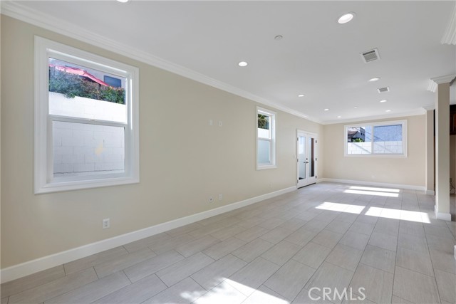 View from Living room to dining room with windows to back patio.