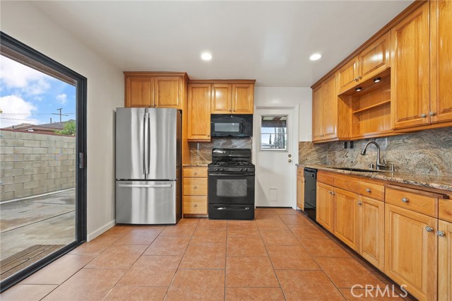 2/3 View of Kitchen with sliding door to driveway