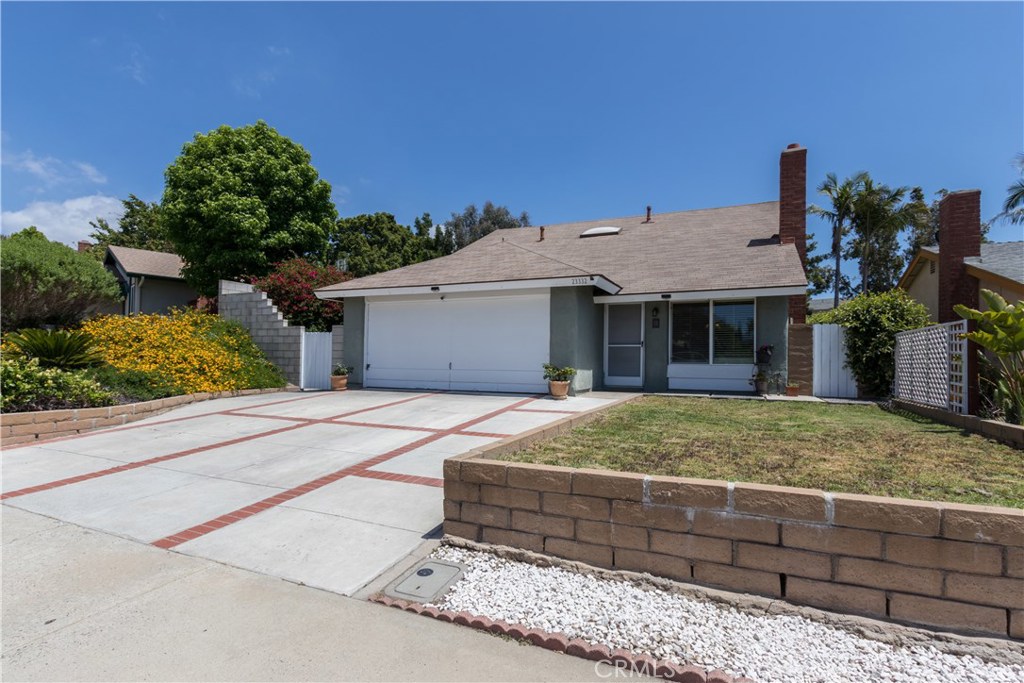 Welcome to 23332 Via Burriana! Located in the heart of Mission Viejo, this lovely home has it all! The oversized driveway with brick inlay immediately draws you in. As you enter, the tall vaulted ceilings and statement adobe style fireplace greets you and makes you feel instantly at home. Wood flooring runs throughout the first level of the home. Modern open concept living/dining/kitchen is all the rage and this home has it! Boasting a spacious layout, the kitchen features granite countertops and newer shaker style cabinets with ample storage and an eat in counter. Plenty of natural light can be enjoyed through the window and sliding door. A custom desk space has also been added to maximize every inch of the space. The well layed out downstairs also features a spacious bedroom(currently being used as a media room/library) with slider that leads to the backyard as well as a full bathroom! As you make your way upstairs, enjoy plenty of natural light courtesy of the gorgeous skylights. Three spacious bedrooms with great windows and ample closet space will be found on the second level of the home. The master bedroom features a large walk in closet. There is one additional bathroom with dual hallway/master access. The "secret garden" backyard is so spacious yet cozy with beautiful mature trees that provide lovely shaded corners to enjoy. Conveniently located near award winning schools and some of the best shopping and dining in the area! Virtual tour.