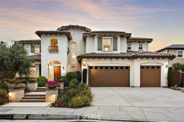 Masterfully built by Toll Brothers, this extraordinary modern-style home in Yorba Linda is full of excellent features. Luxurious upgrades are found throughout the entirety of the home. Windows and glass sliding doors seamlessly compliment the indoor/outdoor flow. The main level boasts a grand foyer that is illuminated by a contemporary style chandelier. Formal living room perfectly transitions into the dining area. The gourmet kitchen holds elegant cabinetry and vast center island. Adjacent to the kitchen is the family room which is outfitted with a gorgeous stone style wall and features sliding glass pocket doors that lead into the outdoor living. The outdoor area boasts a swimming pool and spa as well as an open area that is perfect for entertainment. Also on the main level is a home office as well as downstairs bedroom for added convenience. Residing on the upper level is the astounding master suite which holds a seating area, luxurious bathroom, and walk in closet. Completing the upper level are the remaining generous bedrooms and loft. Additional highlights include laundry room, three car garage, paid off solar, and many more. This estate allows for the comfortable lifestyle of Orange County, all while boasting dazzling aesthetics.