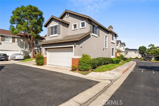 Discover the perfect blend of privacy, comfort, and modern design at 808 N. Siavohn Drive in Orange. This charming 3-bedroom, 2.5-bath townhome is nestled within the gated community of The Stratford with 1,454 square feet of open living space—an ideal choice for a starter home. This move-in-ready gem invites you into a world of minimalist style, making it a perfect first step into homeownership. Step into the bright, airy living room where soaring ceilings and windows flood the space with natural light. A cozy fireplace adds warmth, making it ideal for both relaxed evenings and entertaining. The remodeled kitchen features sleek stainless steel appliances and an inviting eating bar, seamlessly opens to a charming dining area—perfect for family meals and gatherings. Upstairs, enjoy the primary suite, complete with a spa-like bath with dual vanities, a separate glass enclosed shower, soaking tub, and a walk-in closet. Two additional bedrooms and a second bathroom offer plenty of room for family, guests, or a home office. The backyard with a patio and grass yard are perfect for entertaining, BBQs, and outdoor fun. Convenience extends to the indoor laundry area and the attached 2-car garage with overhead storage.Beyond your front door, enjoy all the amenities The Stratford tract of The Huntington has to offer. Take a dip in one of two pools, host a get-together at the clubhouse, or unwind at nearby Grijalva Park, a 26.5-acre oasis featuring sports facilities, playgrounds, and scenic trails. Centrally located, this home offers two gated entries, all maintained by the HOA, and easy access to shopping, dining, and major freeways. Live the elevated lifestyle you deserve in this highly sought-after community. Welcome home to modern comfort at The Stratford!