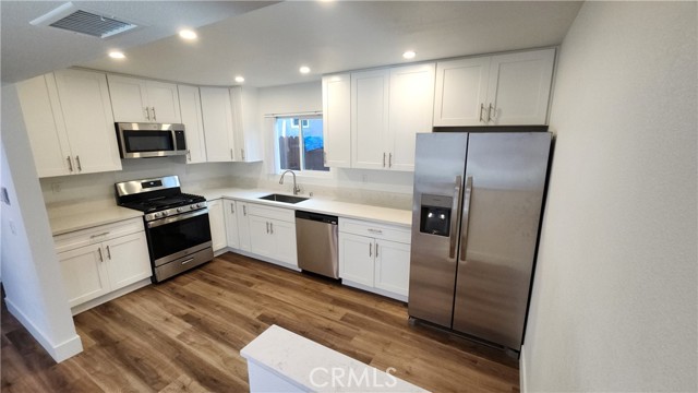 Kitchenhas Quartz counters, stainless steel appliances, soft close cabinets and drawers