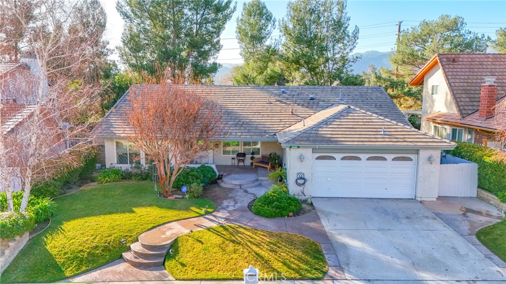 Beautiful 5 Bedroom, 3 Bath SINGLE-STORY home nestled in the highly desired "Vista Ridge" neighborhood of Valencia. Main house is 4bed/2bath and the NEWLY CONSTRUCTED PERMITTED ADU (24302 1/2 Vista Ridge Dr.) is 1bed-STUDIO/1bath. As you enter, you'll be greeted by high ceilings, wood beams, hardwood flooring throughout, gorgeous chandeliers and accenting archways. Lots of natural lighting, open floor plan with the kitchen and living room having direct access to the backyard making it perfect for entertaining family and friends. Great size bedrooms with plenty of closet space. Stunning primary bedroom with double door entry and direct access to the backyard perfect to enjoy your cup of coffee or tea. Primary bathroom has walk-in closet, dual sinks, walk-in shower and soaking tub. Large full guest bathroom with dual sinks and tile shower/tub. Converted garage into permitted ADU 1bed Studio/1bath with its own separate entry and separate address. Utilities are shared with the main house. ADU is perfect for in-law/guest suite or potential rental income. LOW HOA and NO MELLO ROOS. This home has access to the pool, spa, park, tennis and pickleball courts. Conveniently located near the golf course, club house, local shops, dining, great schools and much more!