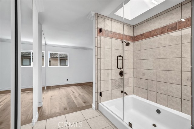 Primary ensuite with sunken tub and skylight over shower. Primary ensuite with sunken tub and skylight over shower.