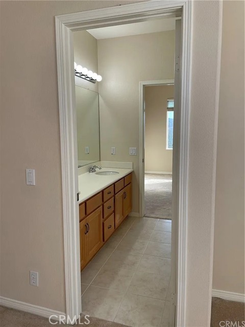 Jack and Jill upper level full bathroom with dual vanities