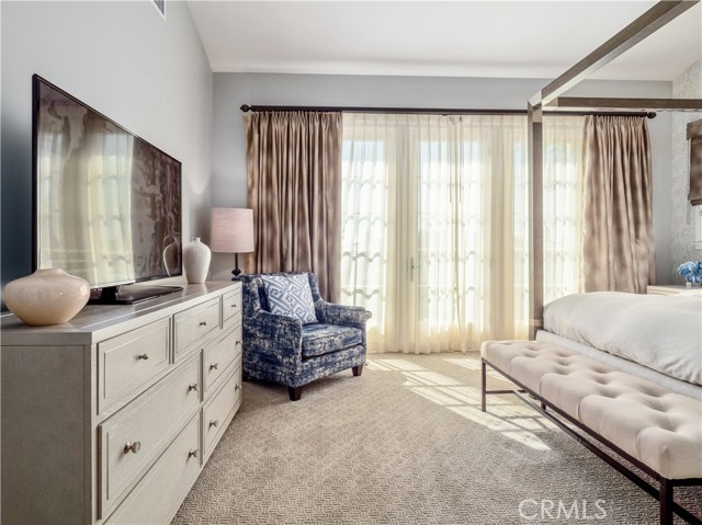 The spacious master suite with French doors leading to the outdoor patio