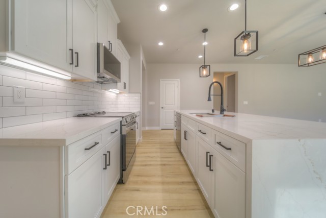Full subway tile backsplash in kitchen.